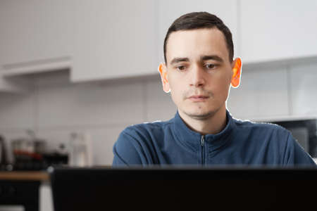 Self entrepreneur sitting and working at his modern apartment.