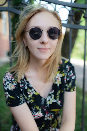 A beautiful woman in trendy round sunglasses