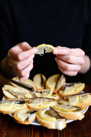 Cooking homemade fish and lemon sandwiches at homeの写真素材