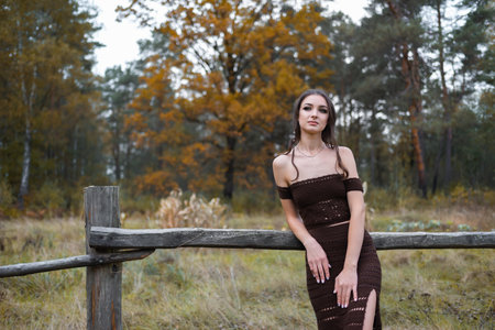 Attractive confident young girl in a beautiful evening dressの写真素材