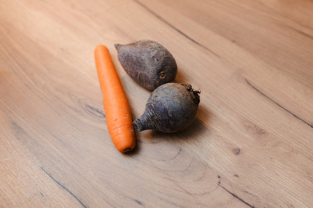 Sweet potatoes and carrot are on a wooden board