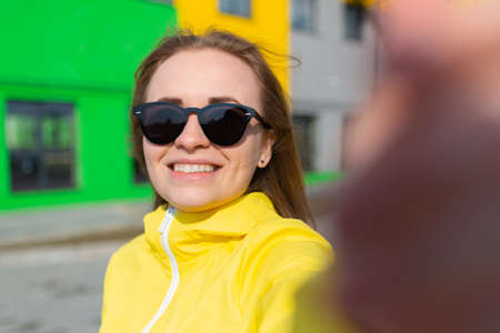 A business woman takes a selfie in the downtown district