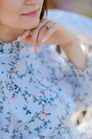 Cropped photo of a woman touching her chin with her hand. Aesthetics and romanceの写真素材
