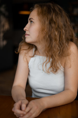 Portrait of a young red-haired girl in a cafeの写真素材