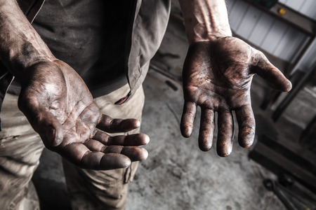 Dirty hands of mechanic at car stationの写真素材