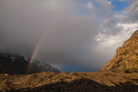 Beautiful evening. Rainbow in the mountains and cloudy skyの写真素材