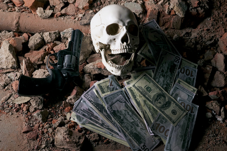 money and a revolver near the skull. Criminal concept 4K