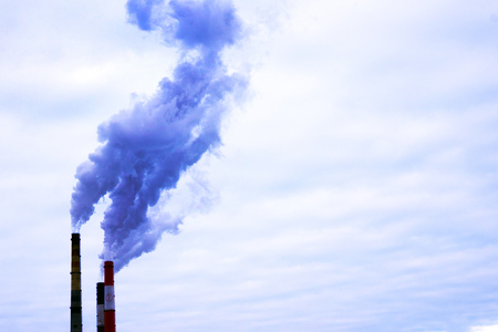 Smoke from two industrial chimneys. Global warming. Air polution.
