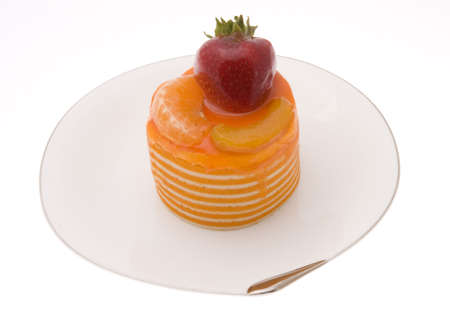 Strawberry cake with two pieces of an orangeの写真素材