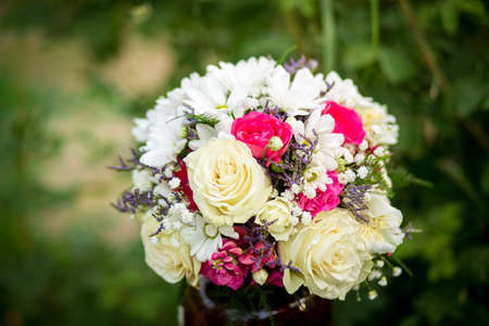 Bouquet of flowers from roses and daisies, flowers for the day of everything, wedding bouquet,...