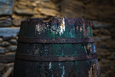 Old rusty barrel in an abandoned warehouseの写真素材