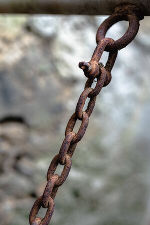 Close up of seamless old rusty chain hanged up from below
