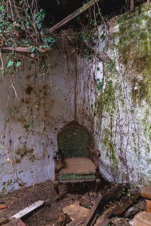 old vintage armchair broken in a abandoned old houseの写真素材