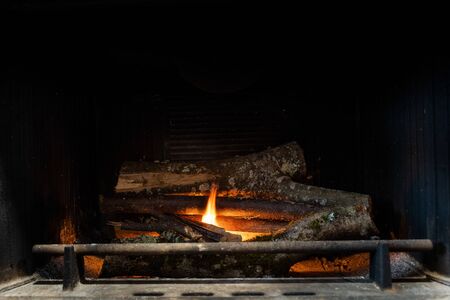 Starting up a fire with wooden sticks inside a chimney