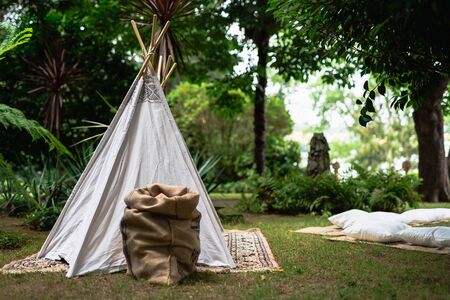 Decoration small tipi indian tent with pillows in the woodsの写真素材