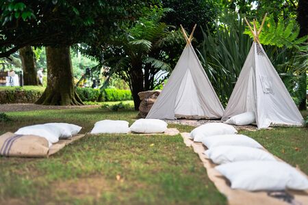 Decoration small tipi indian tent with pillows in the woodsの写真素材