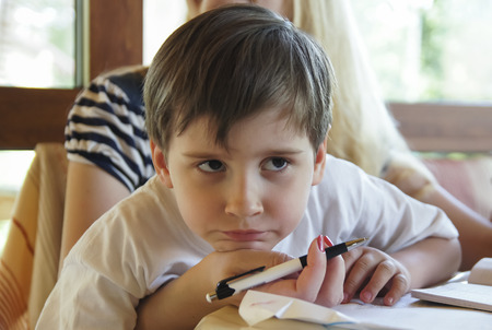 Boy does his homework with motherの写真素材