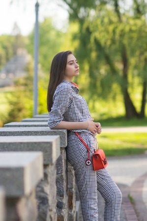 The girl is standing in the park on the bridgeの写真素材