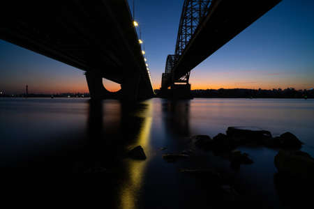 Two bridges over the Dnieper river at nightの写真素材