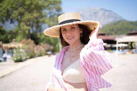 Portrait of a girl in a hat on the beachの写真素材