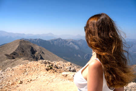 Girl looking at the mountain rangeの写真素材