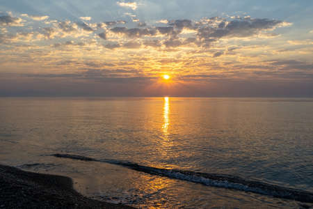orange dawn over the sea coastの写真素材