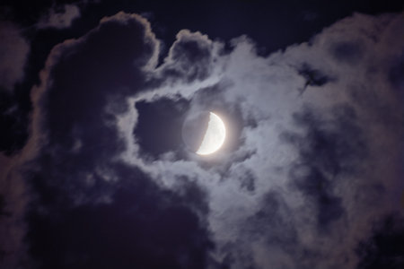 Moon with da Vinci glow among the cloudsの写真素材