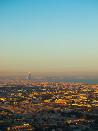 Dubai skyline at sunrise, Burj Al Arab - seven stars hotel, is seen in the backgroundの写真素材