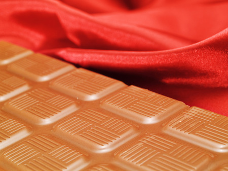 Chocolate on red satinの写真素材