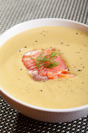 Avocado cream soup with smoked salmon, one portion close up.の写真素材