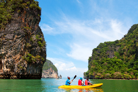 Pang Nga, Thailand - March 16, 2011 : Couple of tourists kayaking in the \hongs\ of Pang Nga Bay in the morning. [description:]The "hongs" are actually collapsed cave systems in the interior of each island, only accessed by tough, purpose-designのeditorial素材