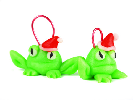 Frogs with santa hat, handmade christmas decoration, isolated on white, made from polymer clay