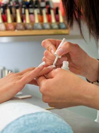 Girl fingernails being manicured.の写真素材