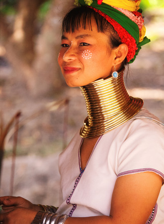 Chian Mai, Thailand - March 07, 2011 : Street portrait of a young long-neck woman. There are 25 copper rings on her neck weighting 9 kilograms. She has the burden to wear them for life.のeditorial素材