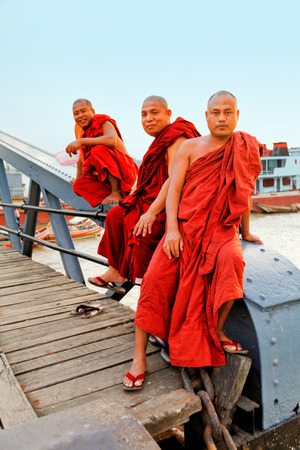 Yangon, Myanmar - February 24, 2011 : Burmese monks posing for a photo on the pier of Yangon at sunsetのeditorial素材