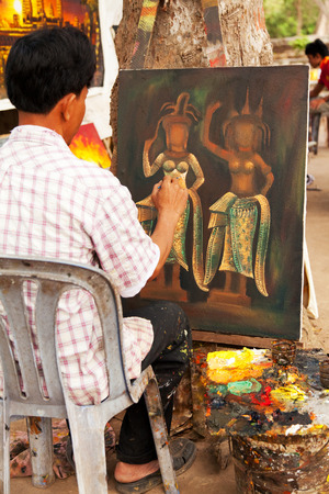 Angkor wat, Cambodia - March 19, 2011 : Middle aged artist drawing a painting of Khmer Gods near Angkor Watのeditorial素材