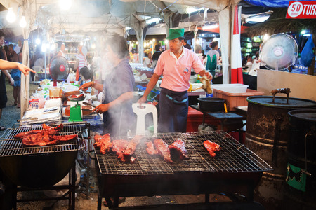 Phuket, Thailand - March 14, 2011 : Thai people selling bbq in a crowdy street in Phuket during the nightのeditorial素材