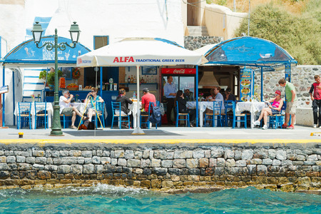 Fira, Greece - May 04, 2012 : Fira small port viewed from a ship which is about to disemark - there are small cafes where tourists can wait for their cruise ship or ferryのeditorial素材
