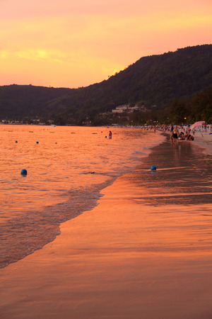 Phuket, Thailand - March 16, 2011 : Tourists enjoying colorful sunset on the beach at the end of the day.のeditorial素材