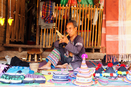 Chiang Mai, Thailand - March 07, 2011 : Portrait of 60 year old Thai man, performing on a typical musical instrumentのeditorial素材