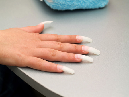 Girl fingernails being manicured.の写真素材