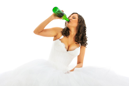 Young bride drinking beer isolated on white backgroundの写真素材