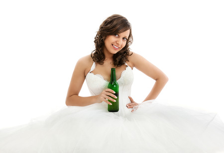 Young bride drinking beer isolated on white backgroundの写真素材