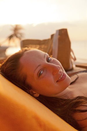Young woman relaxing at the pool in a family hotel in Ko Samui, Thailandの写真素材