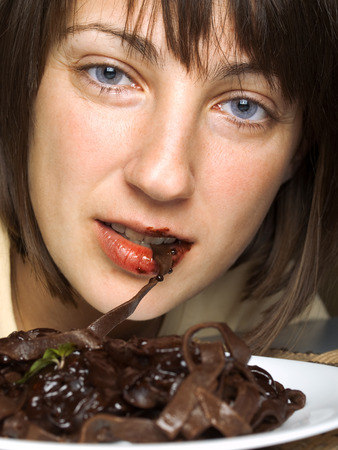 Woman with chocolate tagliatelleの写真素材