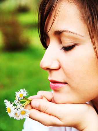 Woman with camomilesの写真素材