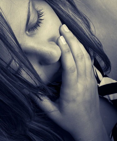 Close up of woman with closed eyes - could express fear or surpriseの写真素材
