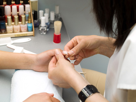 Girl fingernails being manicured.の写真素材