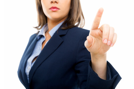 Businesswoman pointing with a finger isolated on white backgroundの写真素材