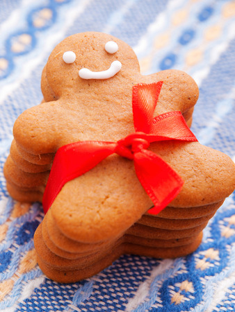 Homemade gingerbread man with red ribbon